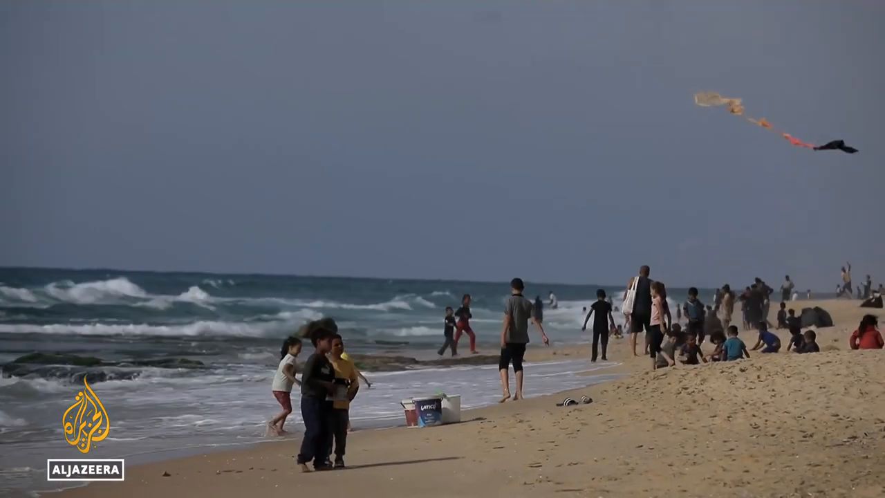  Beach refuge_ Palestinians seek relief from attacks and heat.